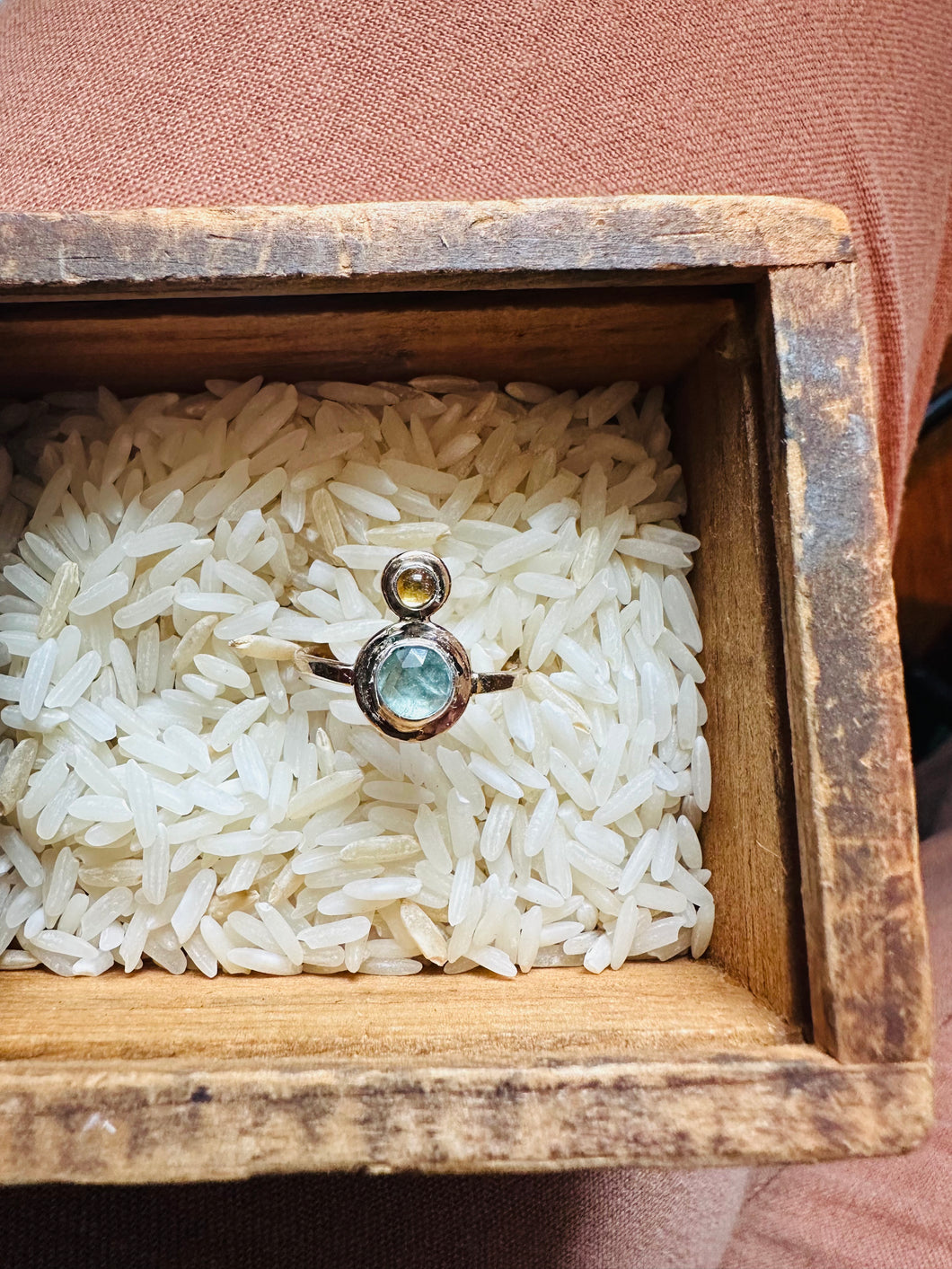 One of a King Ring Handcrafted in 14k Gold Fill and Fine Silver, with Rose Cut Kyanite and Citrine, sitting in a rice filled vintage wooden box