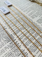 Load image into Gallery viewer, Three 14k Gold Fill Rope Chain Necklaces on a vintage dictionary page with hand stamped Notions of Lovely tags.
