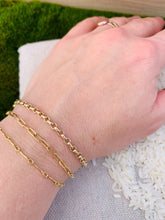 Load image into Gallery viewer, 14k Gold Fill Secretary Chain Bracelet on a bed of natural canvas and grass. Shown with 14k Gold Fill Country Club Chain Bracelet and 14k Gold Fill Magic Hour Chain Bracelet, worn by the artist. 
