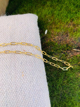Load image into Gallery viewer, 14k Gold Fill Secretary Chain Bracelet on a bed of natural canvas and grass.
