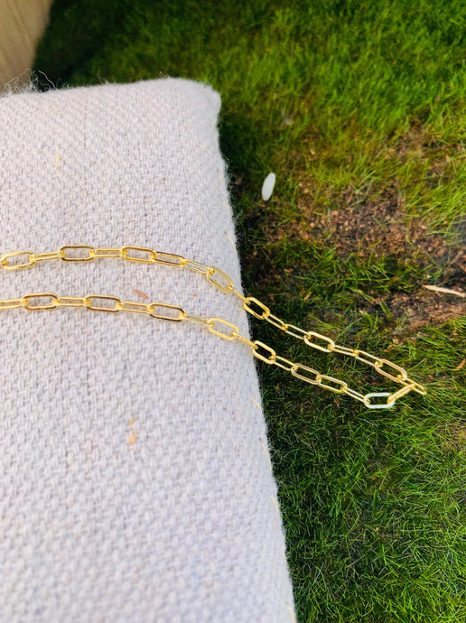 14k Gold Fill Secretary Chain Bracelet on a bed of natural canvas and grass.