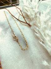 Load image into Gallery viewer, 14k Gold Fill Secretary Luxe Toggle Chain Necklace on white marble with dried grapevines and white feathers.
